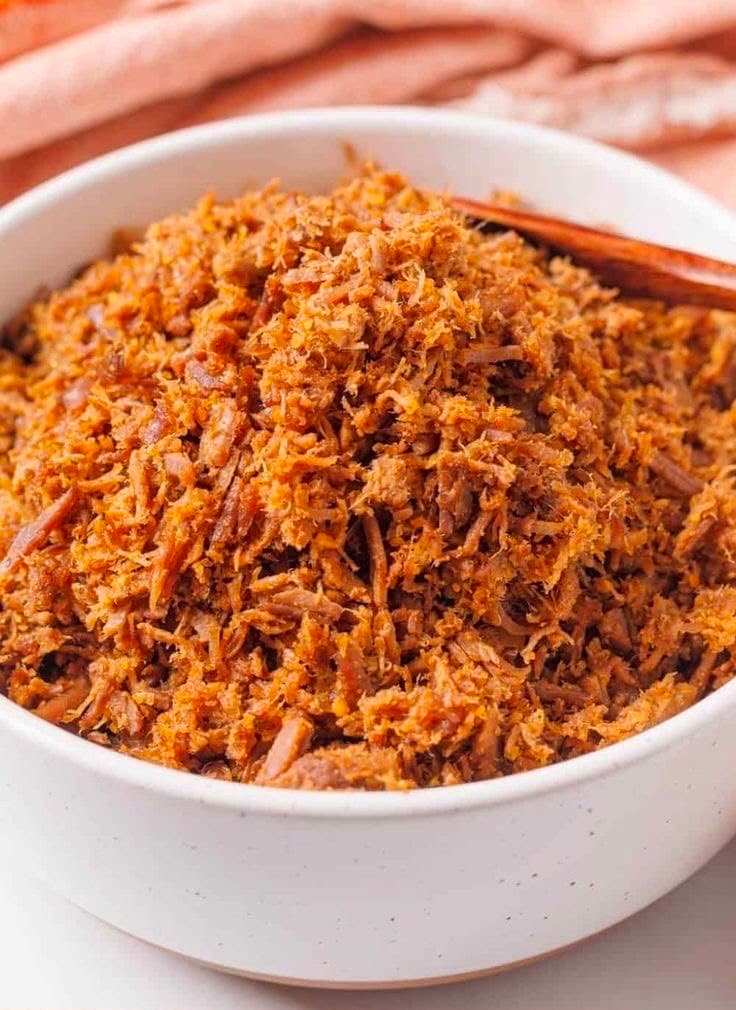 Shredded beef dambu nama piled in a white bowl